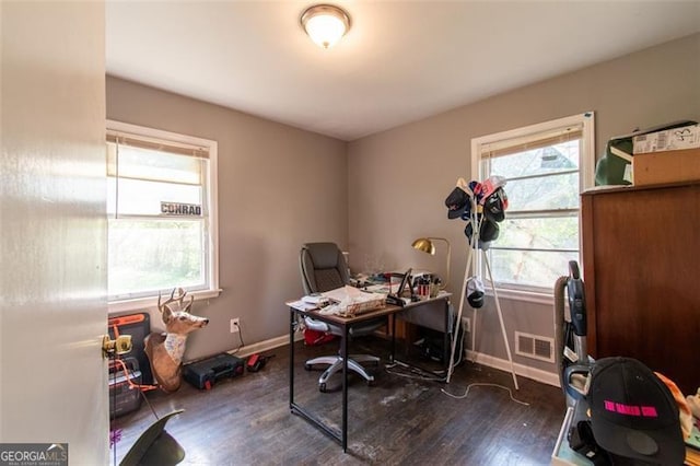 office featuring baseboards, visible vents, and dark wood-type flooring