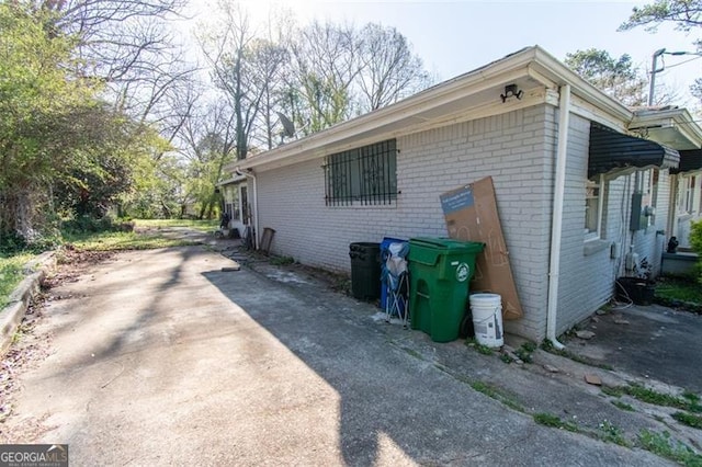 view of property exterior with brick siding