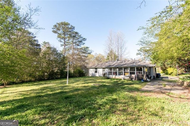 view of yard featuring a sunroom