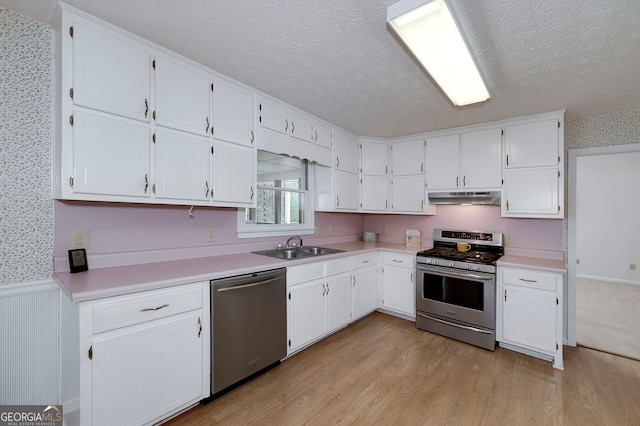 195 Creekside Way, Mcdonough, GA 30252 - kitchen featuring stainless steel appliances, under cabinet range hood, a textured ceiling, white cabinetry, and light wood-style floors