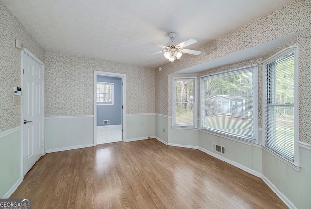 195 Creekside Way, Mcdonough, GA 30252 - spare room with wood finished floors, ceiling fan, and wallpapered walls