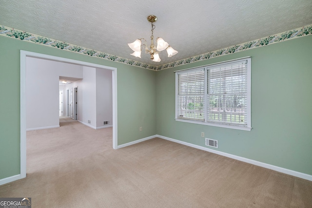 195 Creekside Way, Mcdonough, GA 30252 - spare room featuring a chandelier, carpet flooring, baseboards, and a textured ceiling