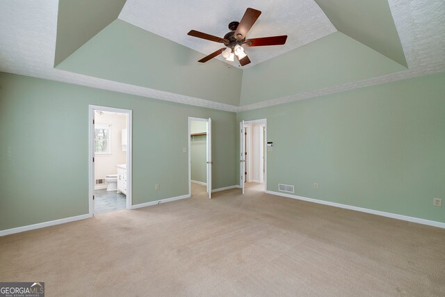 195 Creekside Way, Mcdonough, GA 30252 - unfurnished bedroom featuring light colored carpet, a walk in closet, baseboards, ensuite bathroom, and a textured ceiling