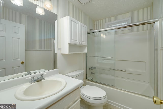 195 Creekside Way, Mcdonough, GA 30252 - bathroom featuring wallpapered walls, toilet, vanity, enclosed tub / shower combo, and a textured ceiling