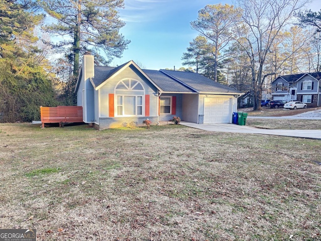 1952 Marbut Forest Dr, Lithonia, GA 30058 - view of front of house featuring a front lawn, a chimney, a deck, and a garage