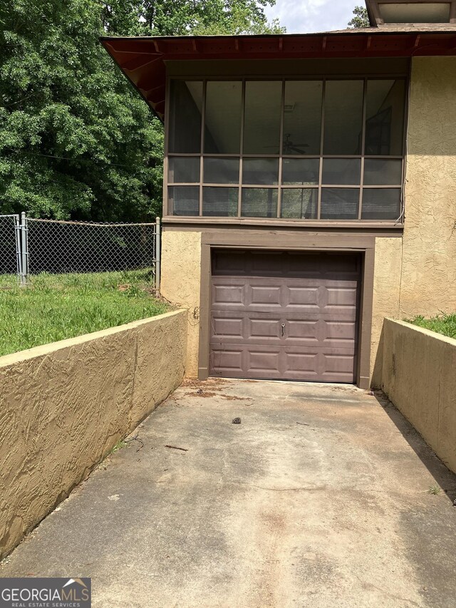 1288 Lakewood Dr NE, Conyers, GA 30013 - garage featuring fence and driveway