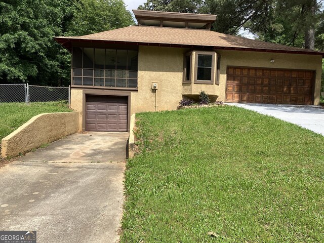 1288 Lakewood Dr NE, Conyers, GA 30013 - prairie-style home featuring fence, stucco siding, concrete driveway, and a front lawn