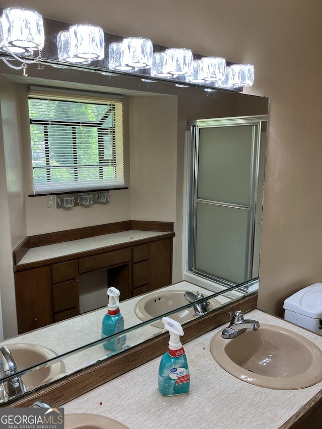 full bathroom featuring an enclosed shower, toilet, and vanity
