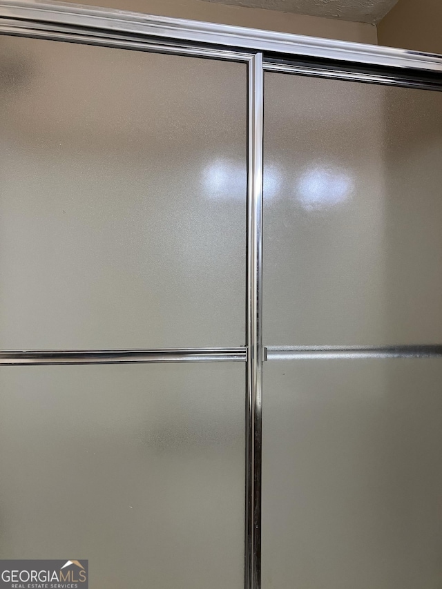 bathroom with a shower with door