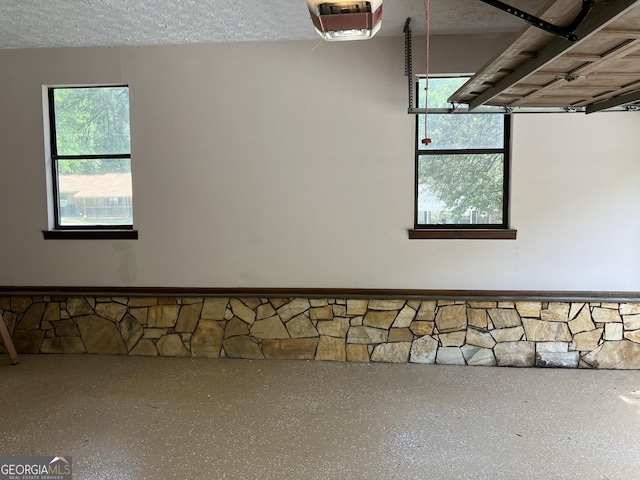 interior space with a textured ceiling and speckled floor