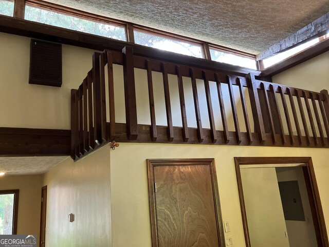 1288 Lakewood Dr NE, Conyers, GA 30013 - stairway featuring a textured ceiling