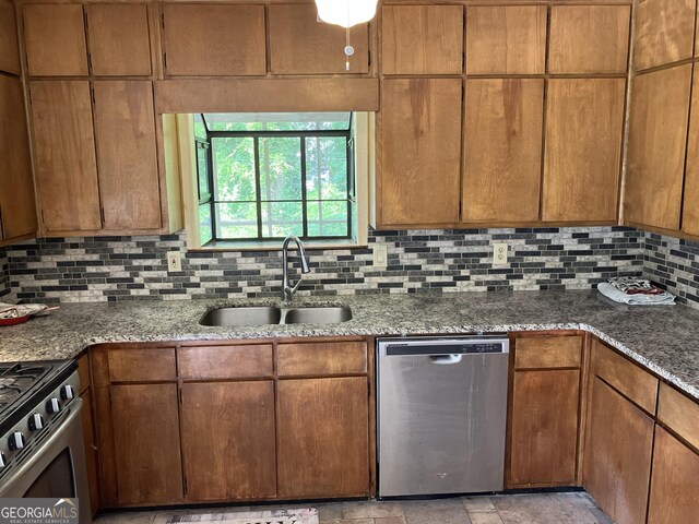 1288 Lakewood Dr NE, Conyers, GA 30013 - kitchen with stone counters, appliances with stainless steel finishes, decorative backsplash, and a sink