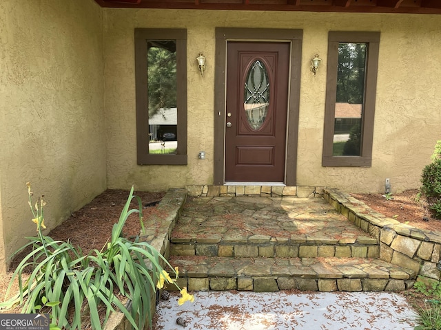view of exterior entry with stucco siding