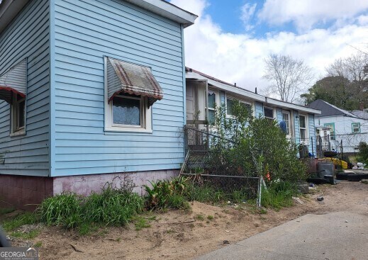 view of side of property featuring fence