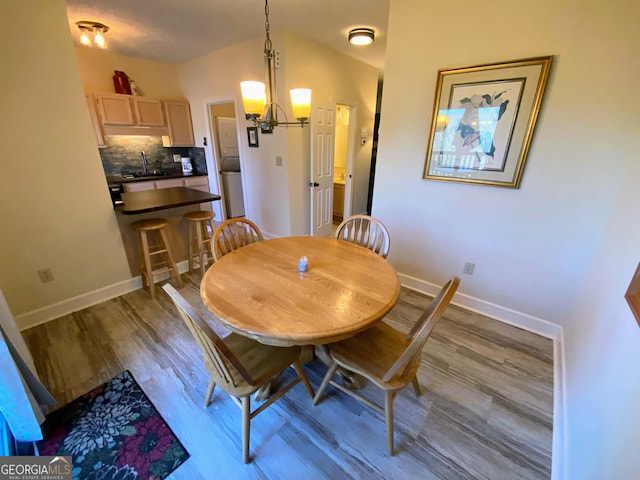 dining room featuring baseboards and wood finished floors