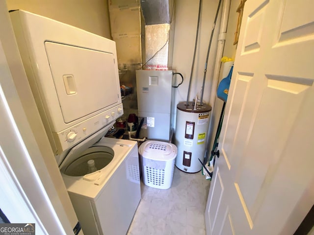 washroom featuring stacked washer / dryer, laundry area, and electric water heater