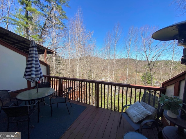 wooden deck featuring a view of trees