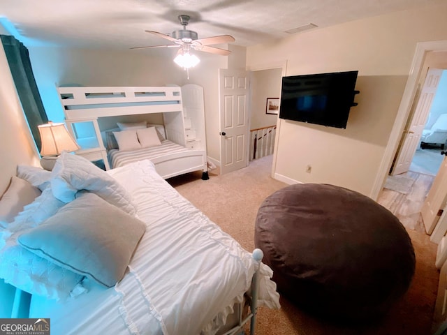 carpeted bedroom featuring baseboards, ceiling fan, and visible vents