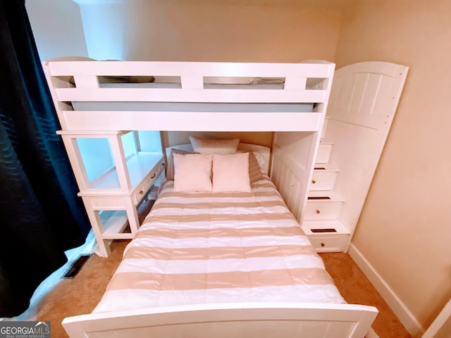 carpeted bedroom with baseboards