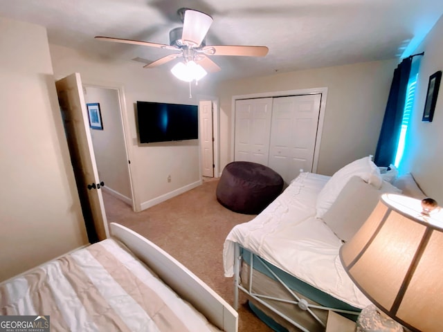bedroom featuring baseboards, a closet, carpet, and a ceiling fan