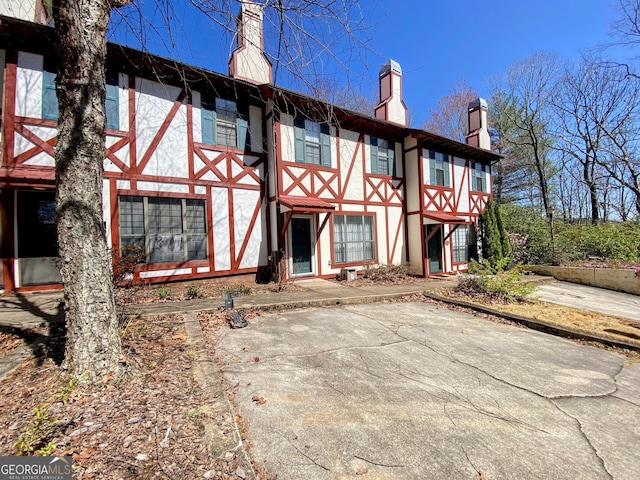 back of property featuring stucco siding and a chimney