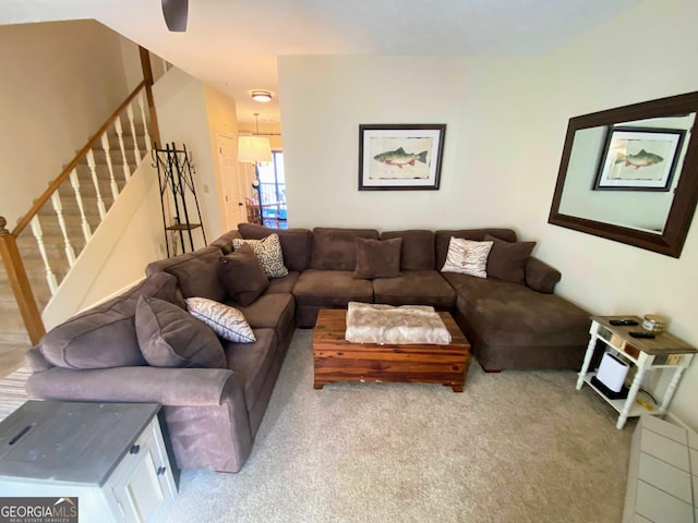 living room featuring carpet and stairway