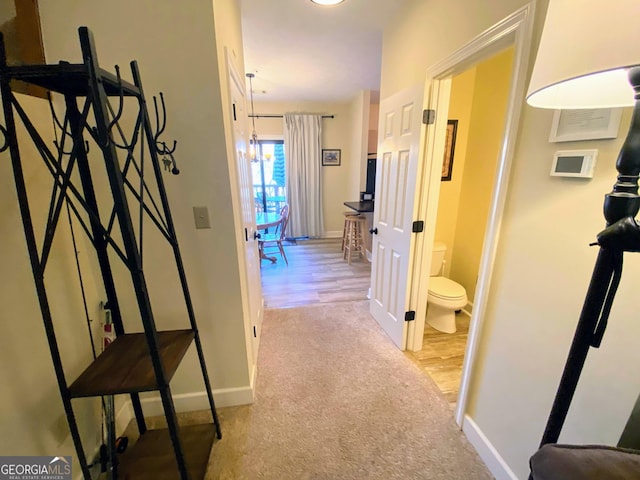 hall with carpet floors and baseboards