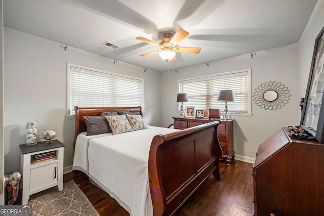 bedroom featuring baseboards, visible vents, ceiling fan, and dark wood-style flooring