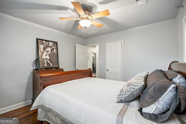 bedroom with baseboards, ceiling fan, visible vents, and dark wood finished floors