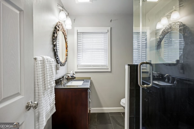 bathroom with tile patterned flooring, vanity, toilet, baseboards, and a shower stall