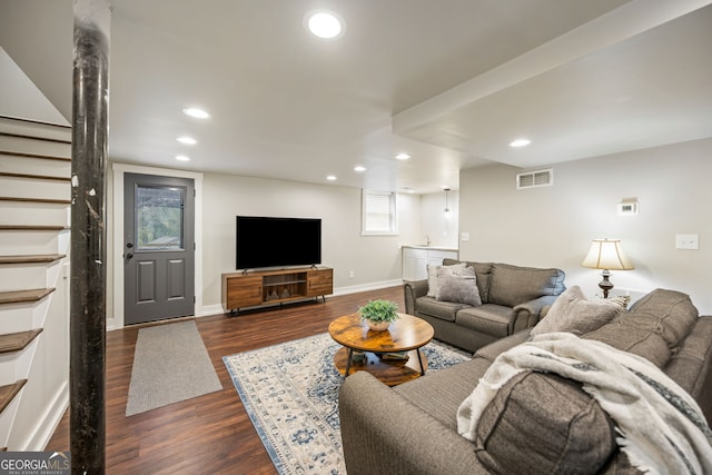 living room featuring visible vents, baseboards, recessed lighting, stairway, and dark wood-style floors