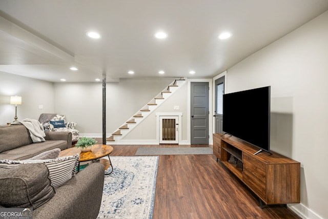 living area featuring recessed lighting, baseboards, stairs, and dark wood finished floors