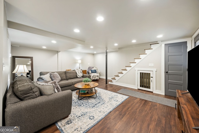 living room featuring dark wood-type flooring, stairway, baseboards, and recessed lighting
