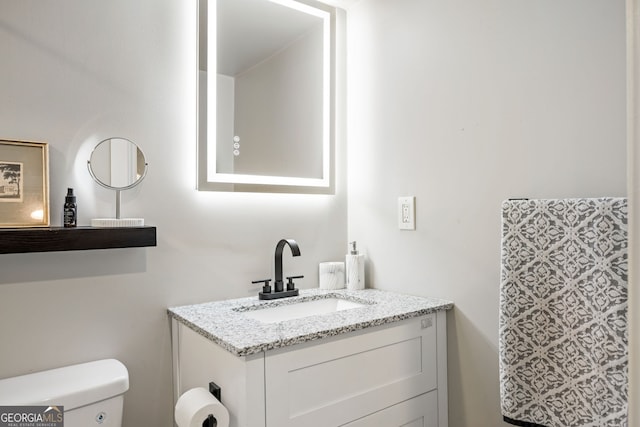 bathroom with toilet and vanity
