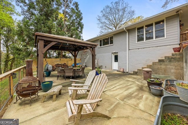 view of patio / terrace featuring a gazebo, fence, and outdoor dining space