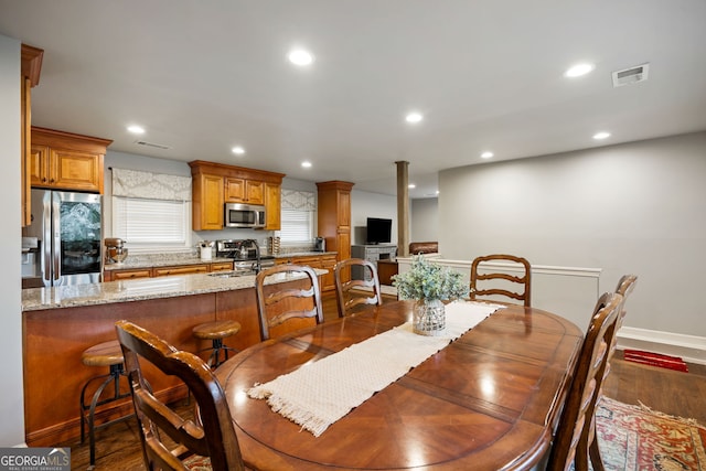 dining area featuring ornate columns, dark wood-style flooring, visible vents, and recessed lighting