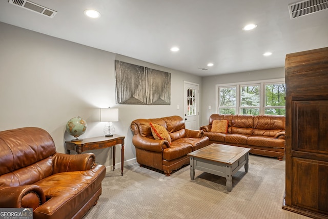 living area featuring recessed lighting, light carpet, baseboards, and visible vents