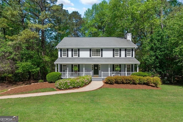 2731 Old Coach Rd, Duluth, GA 30096 - colonial-style house with a porch, a chimney, and a front lawn