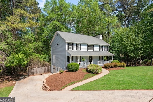 2731 Old Coach Rd, Duluth, GA 30096 - view of front of home with covered porch, concrete driveway, a front lawn, an attached garage, and view of scattered trees