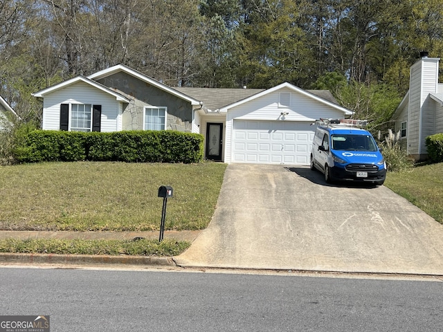 ranch-style house featuring an attached garage, a front yard, and concrete driveway