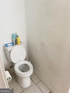 bathroom with tile patterned flooring and toilet