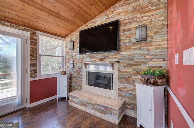 living area with lofted ceiling, wood ceiling, wood finished floors, a fireplace, and baseboards