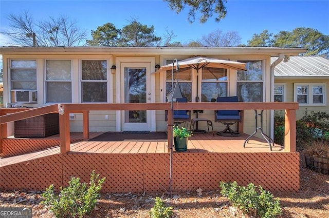 back of property featuring a deck