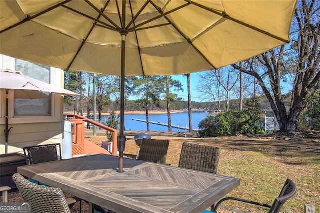 view of patio / terrace with outdoor dining space and a water view