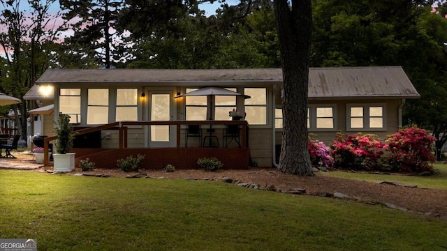 view of front of house featuring a front yard and a sunroom