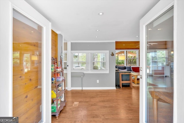 entryway with baseboards, wood finished floors, and recessed lighting