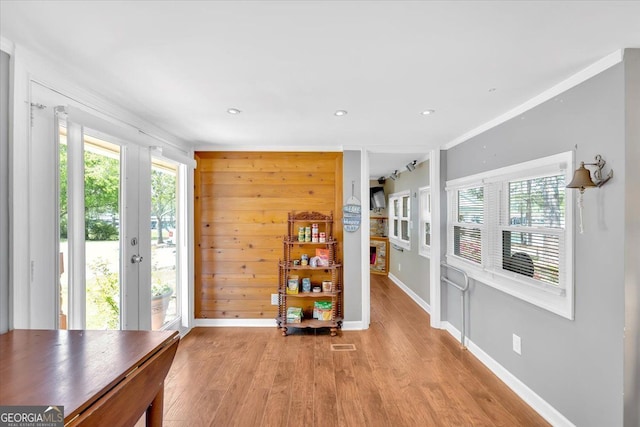 living area featuring baseboards, light wood finished floors, french doors, and recessed lighting