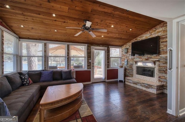 living room featuring lofted ceiling, wood ceiling, a ceiling fan, a fireplace, and wood finished floors