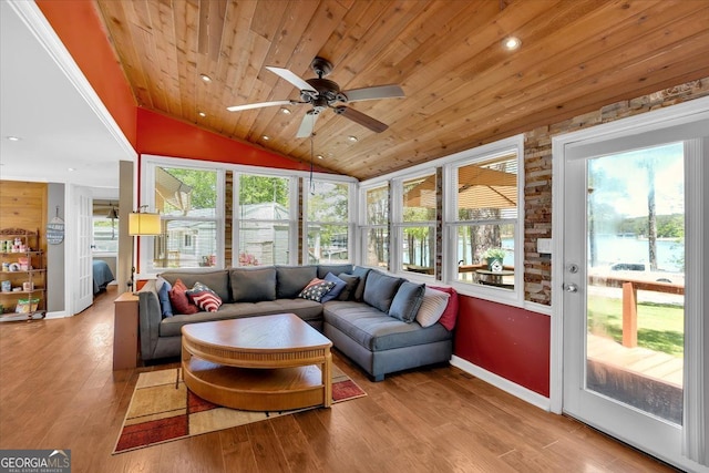 sunroom featuring wood ceiling, ceiling fan, outdoor lounge area, vaulted ceiling, and wood finished floors