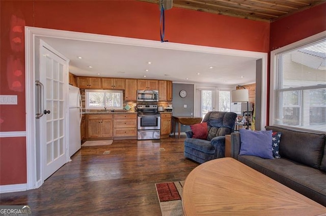 living room with dark wood-style flooring and recessed lighting